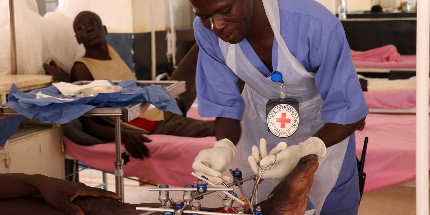 A doctor working on a patients foot in Wau. Teaching hospital, South Sudan