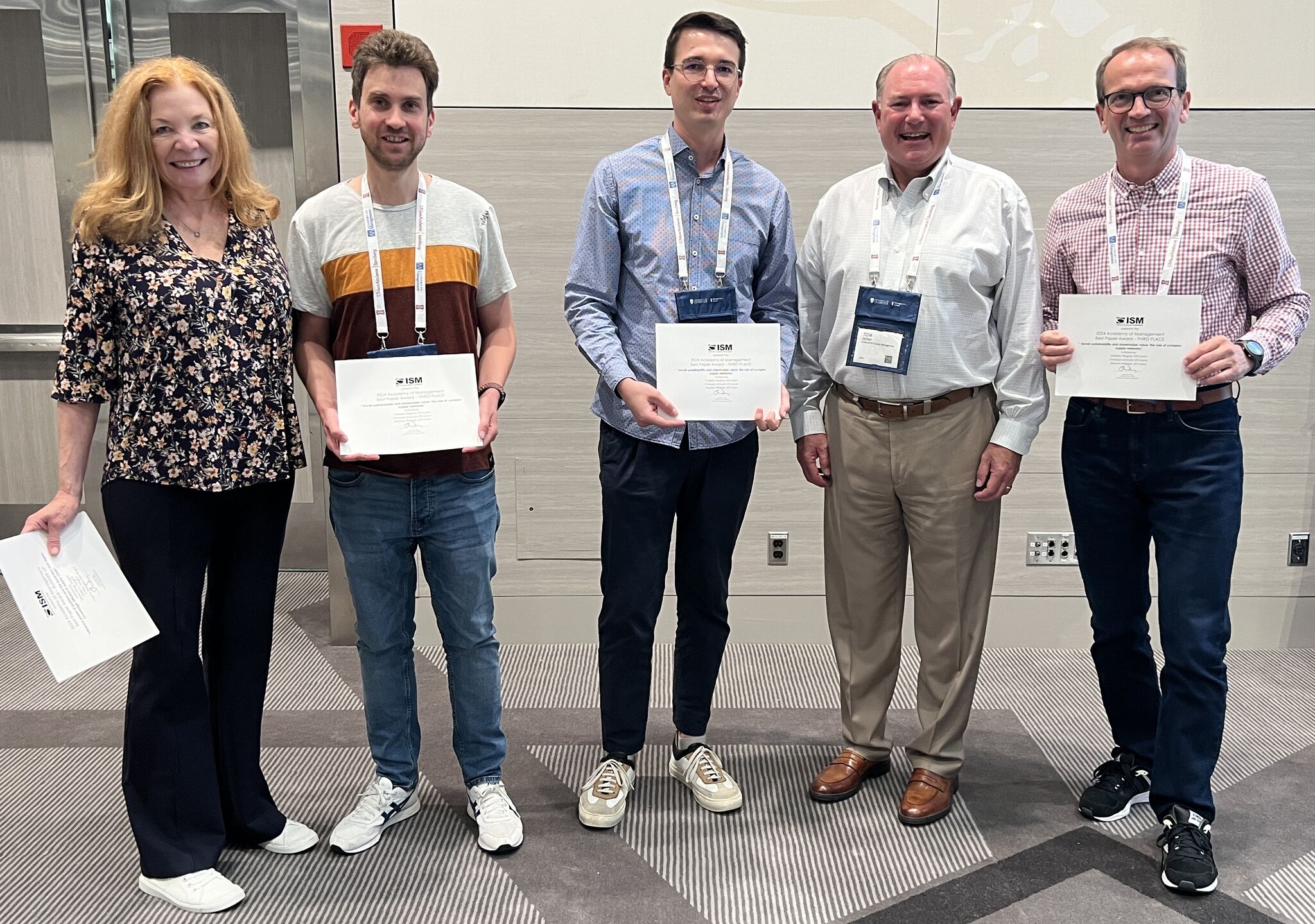 The award winners standing and holding their certificates with ISM-personell.