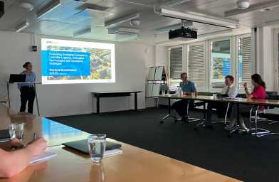 Sarah presenting her defense and an audience listening