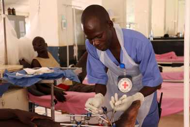 A doctor working on a patients foot in Wau. Teaching hospital, South Sudan